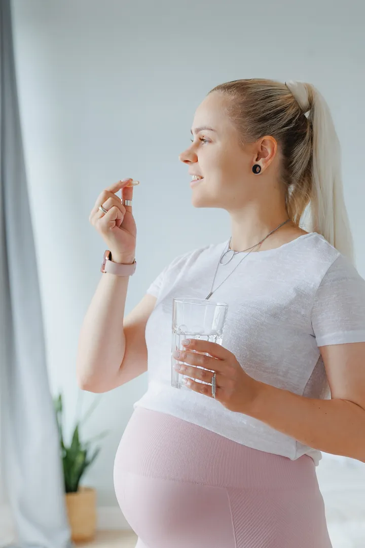 A pregnant woman takes an iron supplement