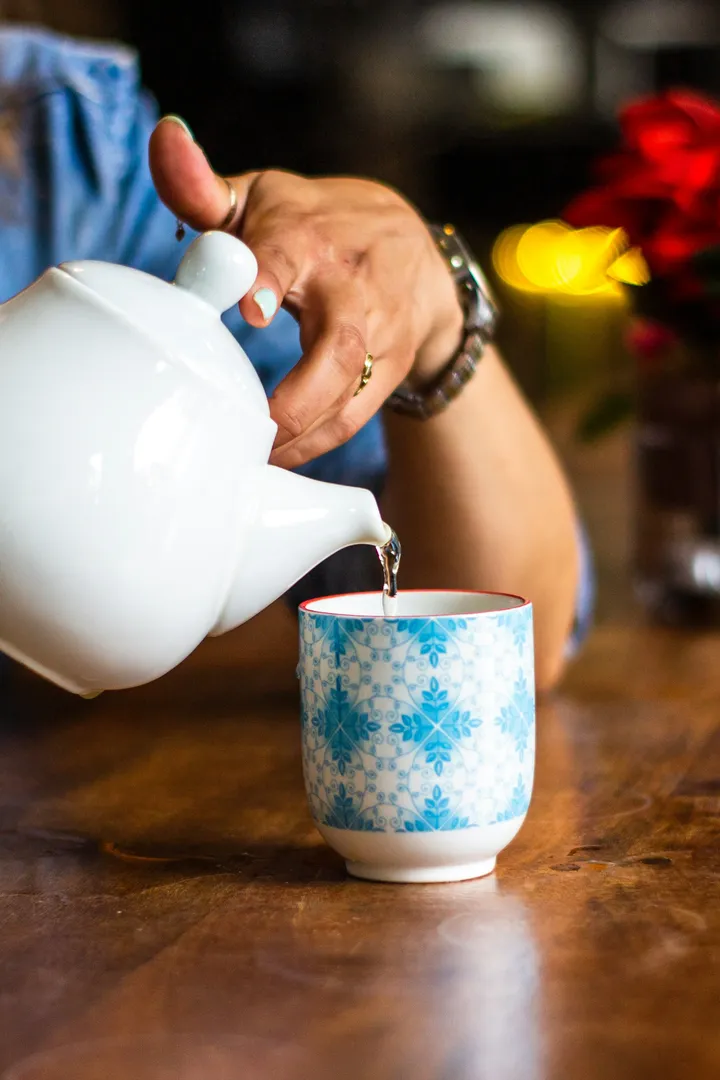 A woman pours a cup of tea